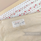 Petershams Millinery Supplies vintage 15mm off-white and red cotton guipure lace trim with a scalloped design.
