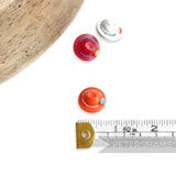 Petershams Millinery Supplies vintage hat buttons in red, orange, and white, 18mm wide, with raised trim relief.