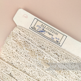 Petershams Millinery Supplies vintage ivory cotton guipure lace trim with foxing on a card, 16mm wide.