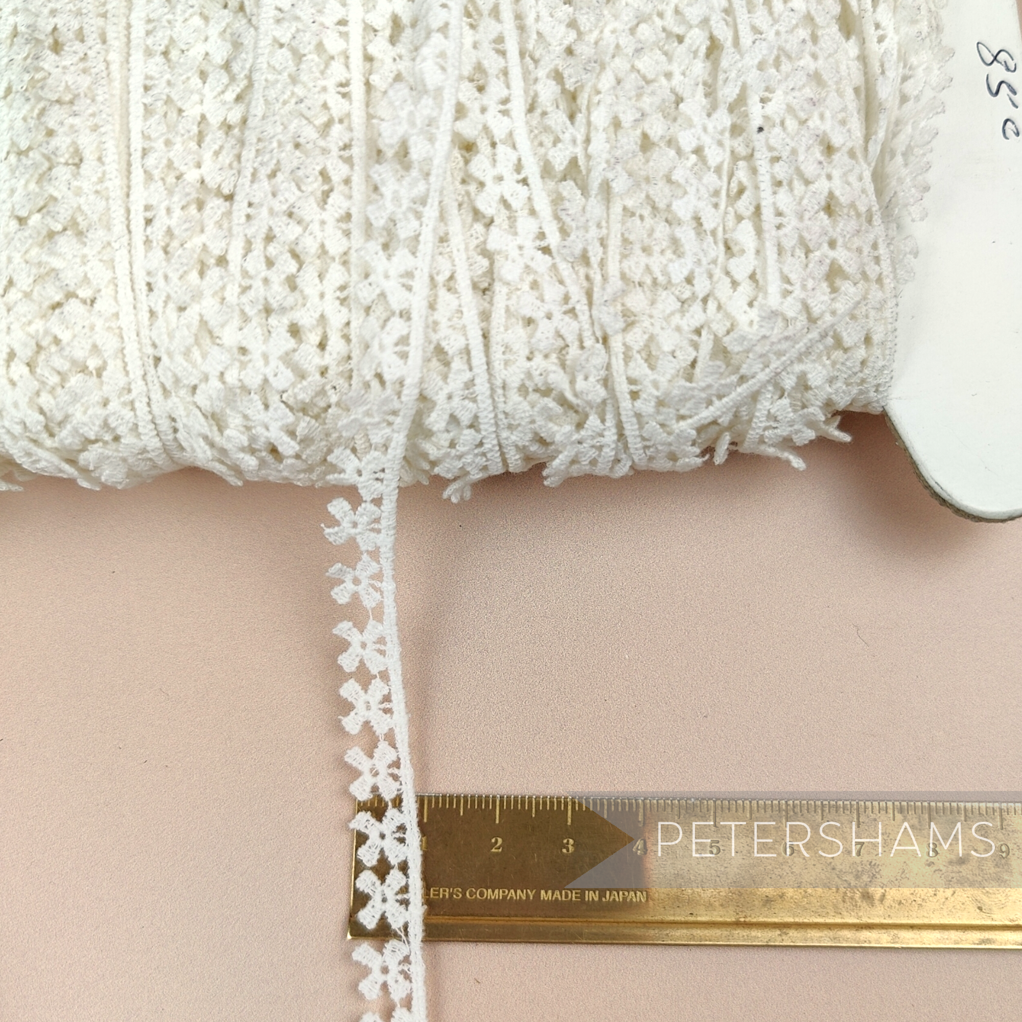Petershams Millinery Supplies vintage 10mm ivory cotton guipure lace trim with a delicate windmill pattern.