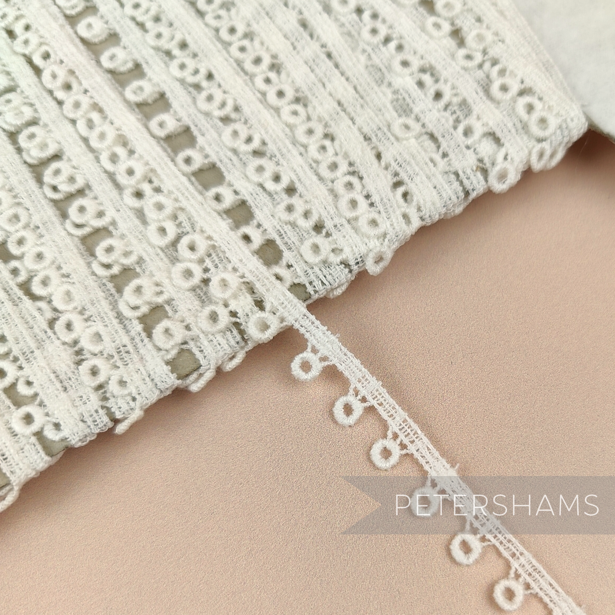 Petershams Millinery Supplies vintage 10mm ivory guipure lace trim with a prized doughnut pattern design.