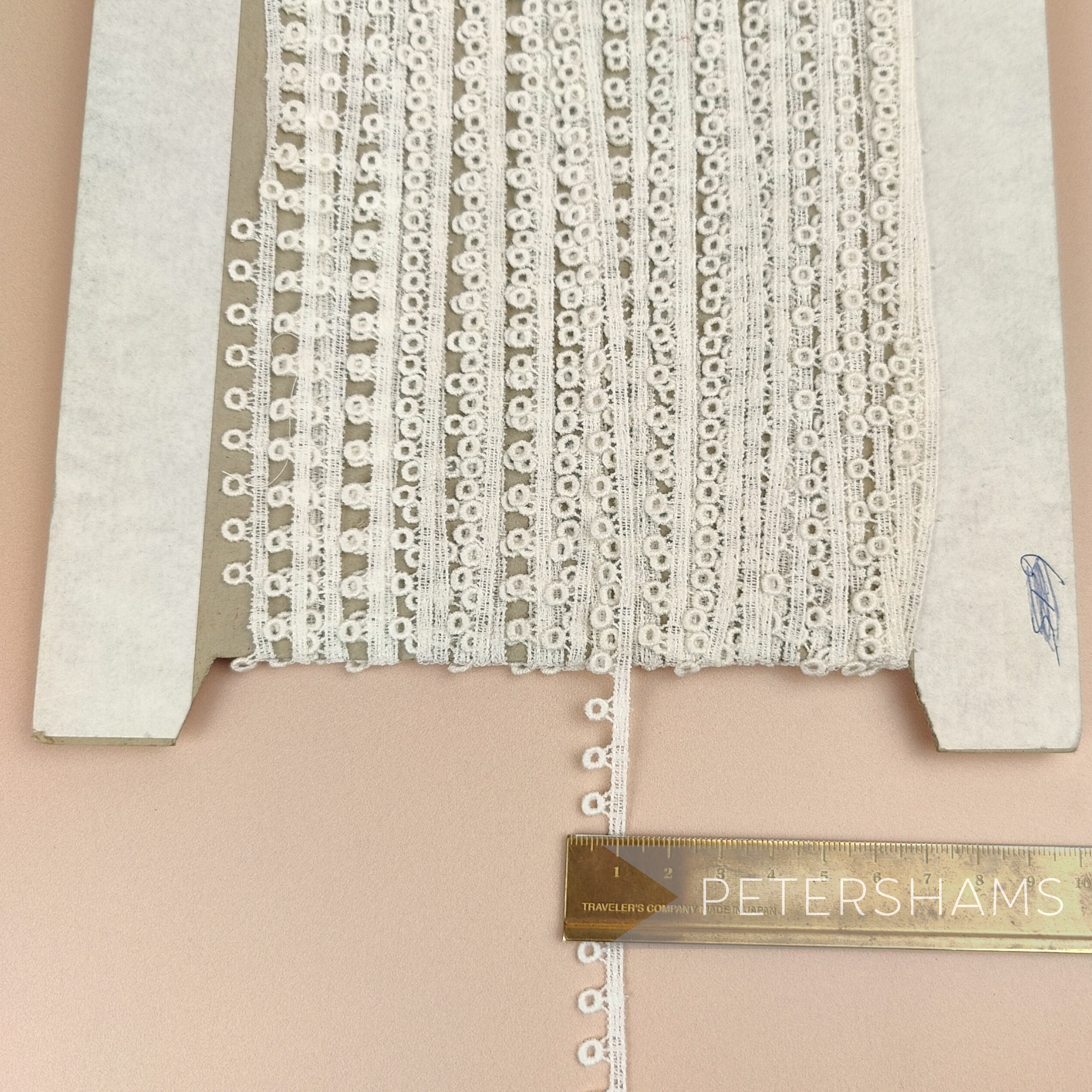 Petershams Millinery Supplies vintage ivory guipure lace trim with a prized doughnut pattern on a cardboard spool.