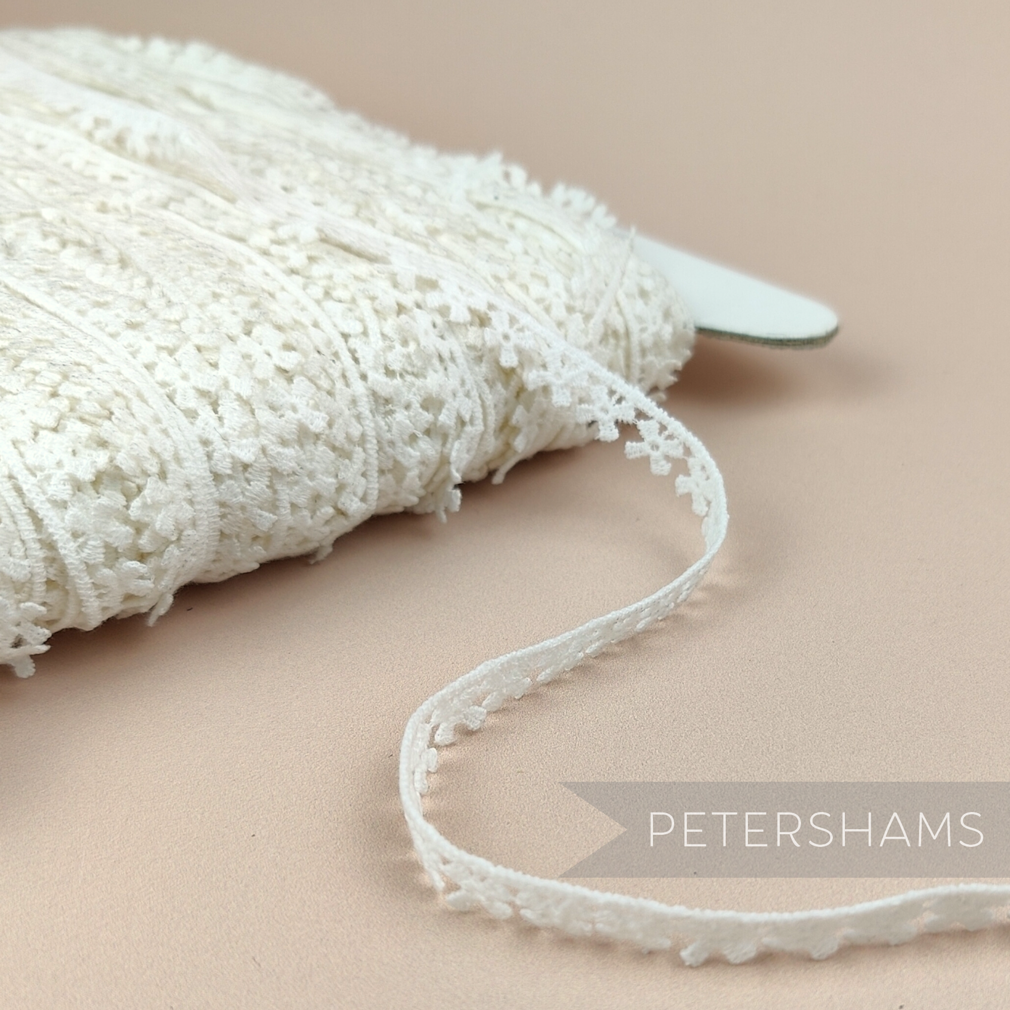 Petershams Millinery Supplies vintage 10mm ivory cotton guipure lace trim with a delicate windmill pattern.
