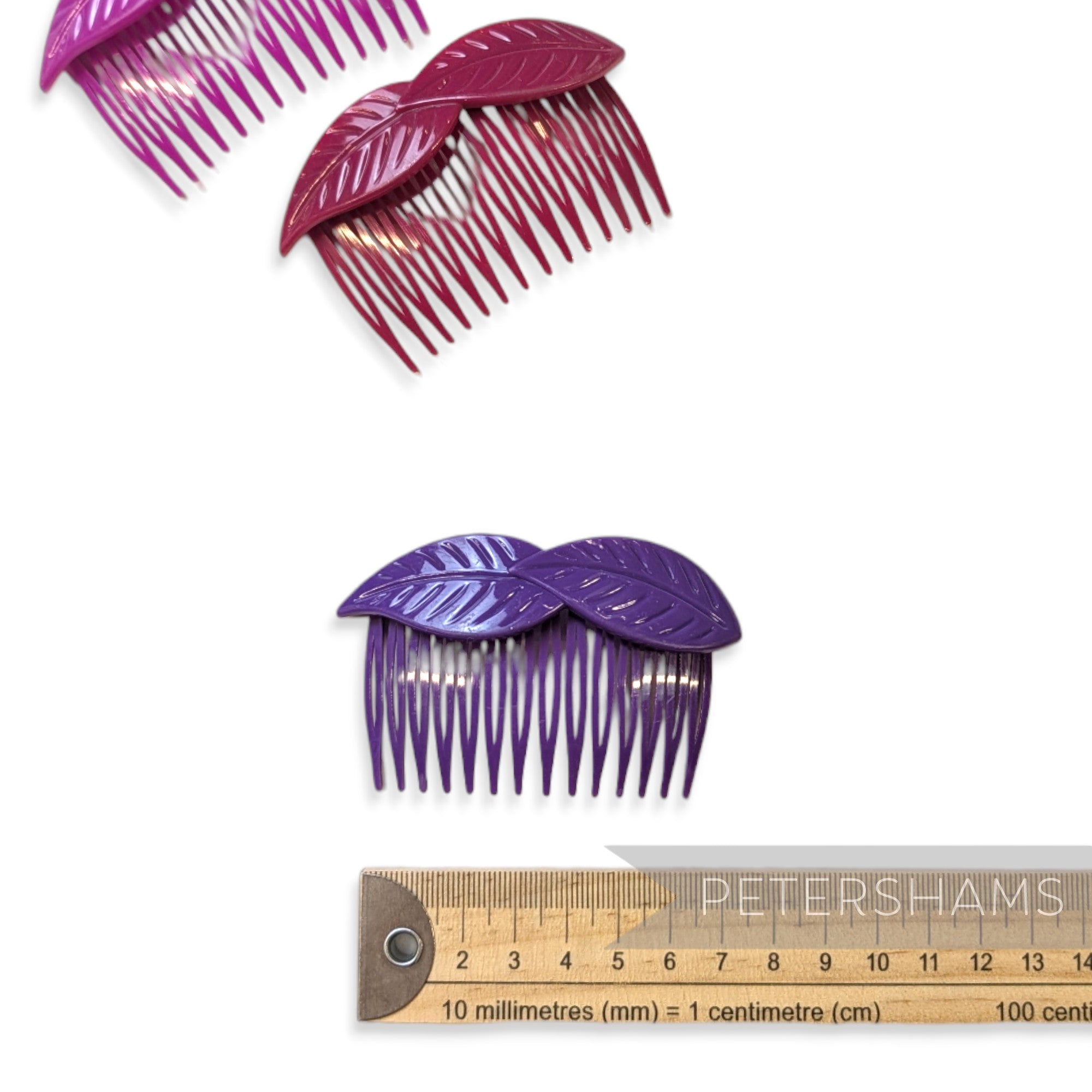 Petershams Millinery Supplies vintage 1980s purple plastic hair combs with a layered leaf design