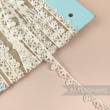Petershams Millinery Supplies vintage 1940s natural cotton guipure lace trim with a delicate dropped leaf design.