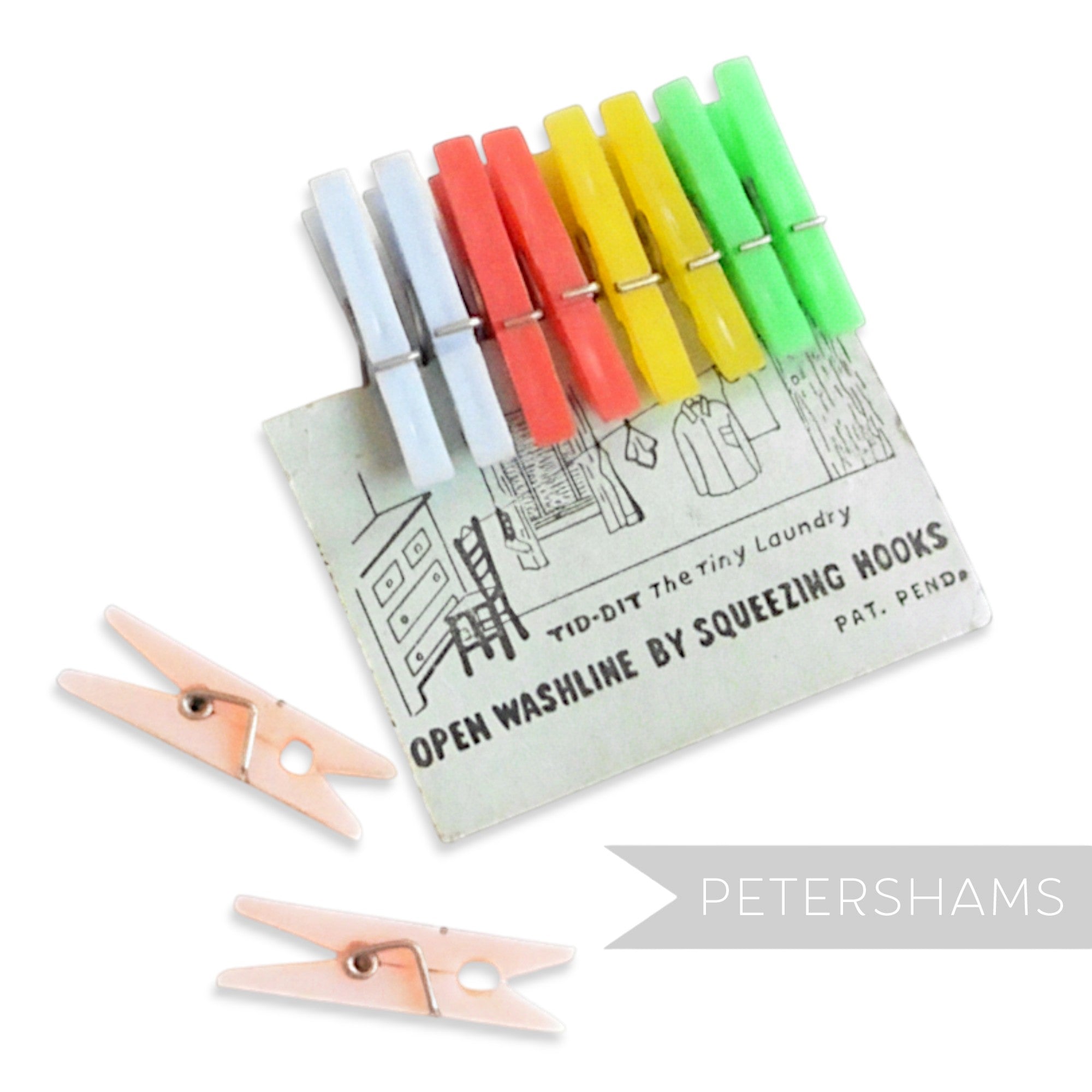 Petershams Millinery Supplies vintage mini plastic clothes pegs in pastel blue, red, yellow, and green on a card.
