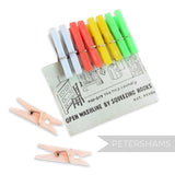 Petershams Millinery Supplies vintage mini plastic clothes pegs in pastel blue, red, yellow, and green on a card.