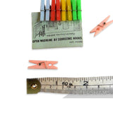 Petershams Millinery Supplies vintage Tid-Dit mini plastic clothes pegs in blue, red, yellow, and green on card, with loose pink pegs.