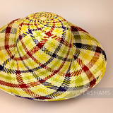 Petershams Millinery Supplies vintage Ecuador Panama straw capeline hat body with a multi-tone red, green, yellow spiral swirl pattern.