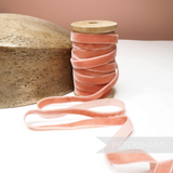 Petershams Millinery Supplies 10mm vintage velvet ribbon on a wooden spool next to a wooden hat block.
