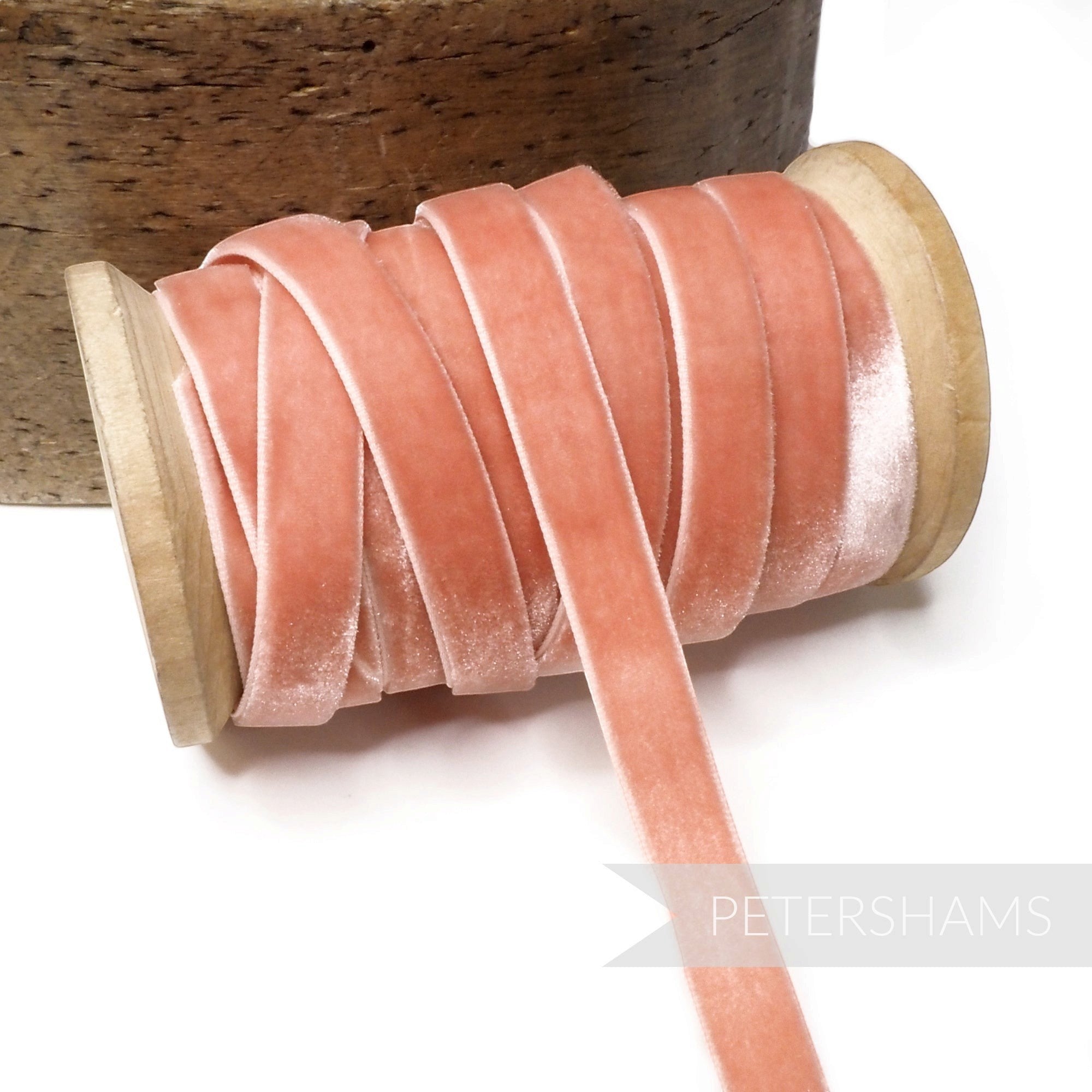 Petershams Millinery Supplies 9mm vintage dusty pink velvet ribbon on a wooden spool for millinery and craft projects.