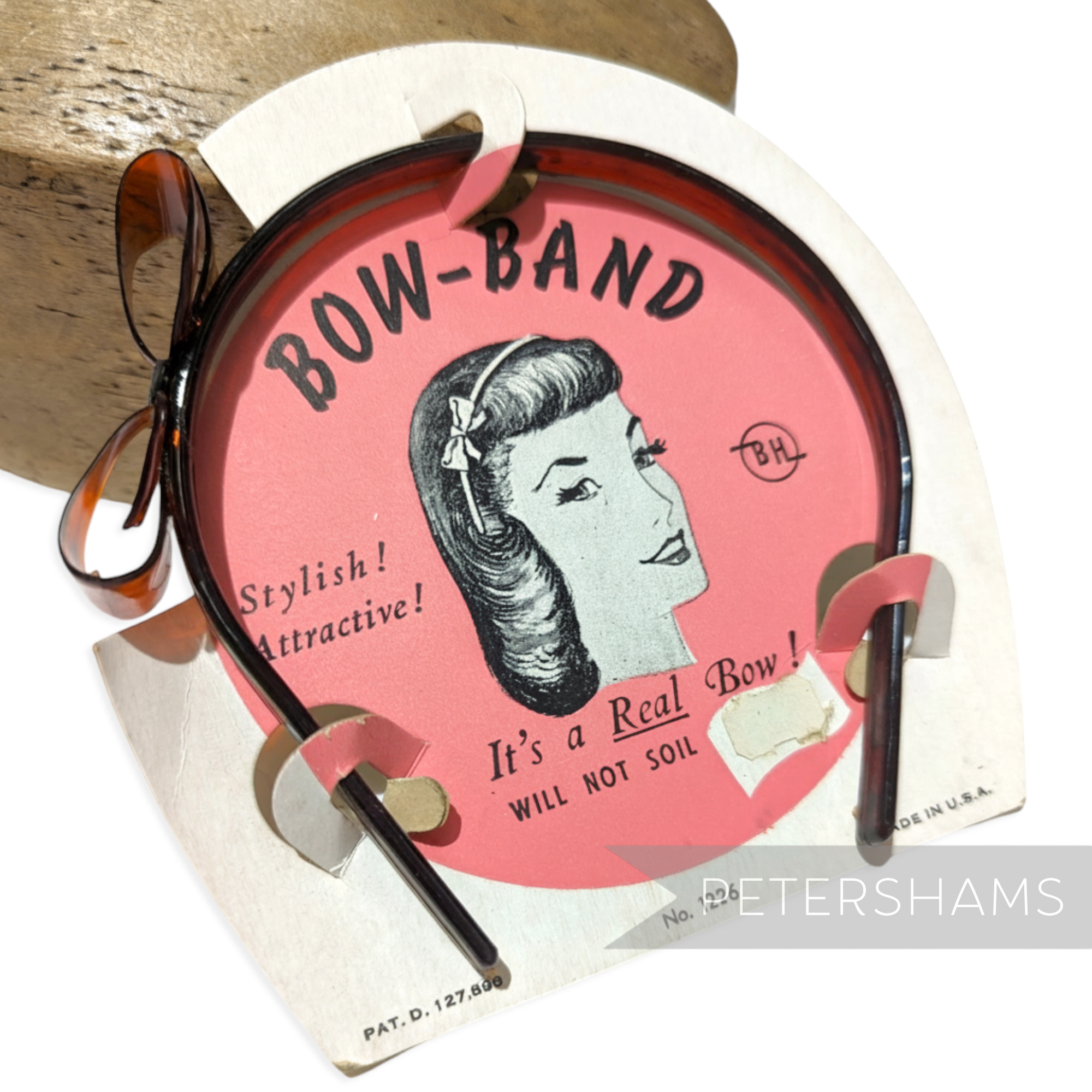 Petershams Millinery Supplies vintage 1950s brown plastic headband with a bow, on original card packaging.