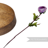 Petershams Millinery Supplies vintage 1960s purple silk rosebud with wired stem and leaves on a wooden millinery block