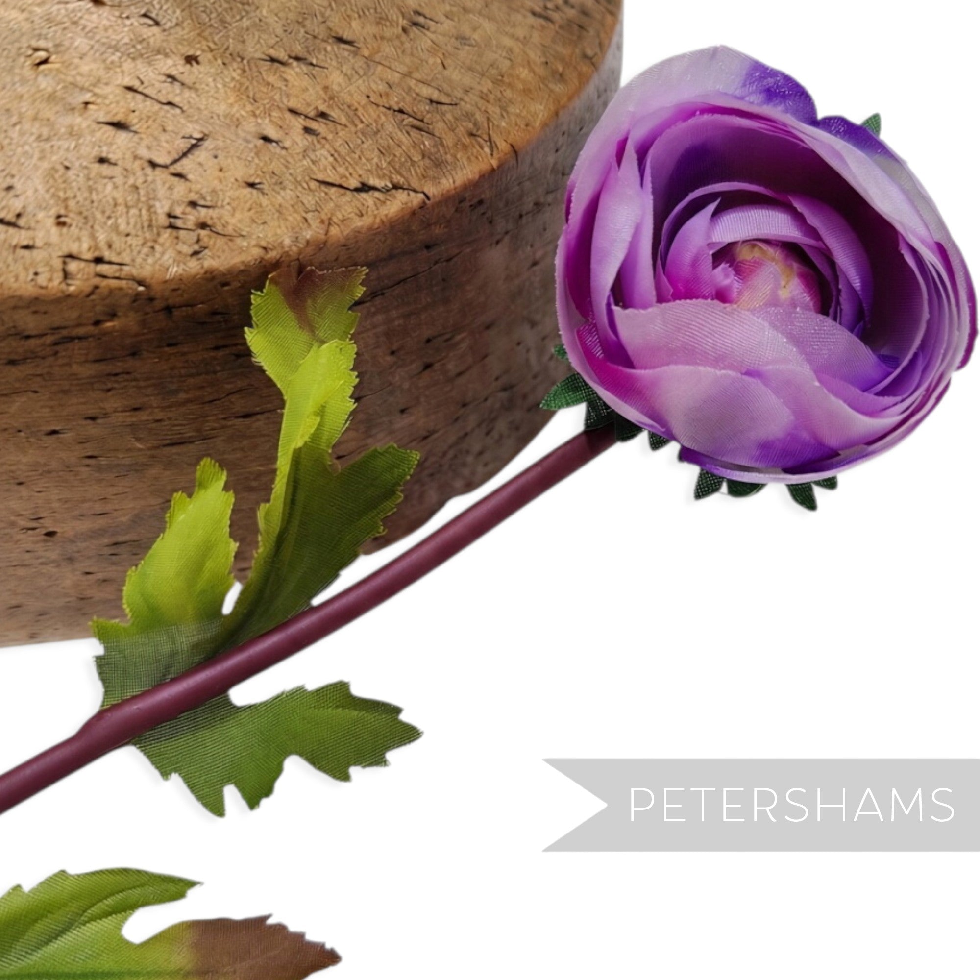Petershams Millinery Supplies vintage 1960s purple silk rosebud with wired green leaves and stem on a wooden block