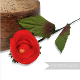 Petershams Millinery Supplies vintage 1960s red silk rosebud with wired green leaves and stem on a wooden millinery block