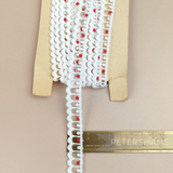 Petershams Millinery Supplies vintage 15mm off-white and red cotton guipure lace trim with a scalloped edge design.