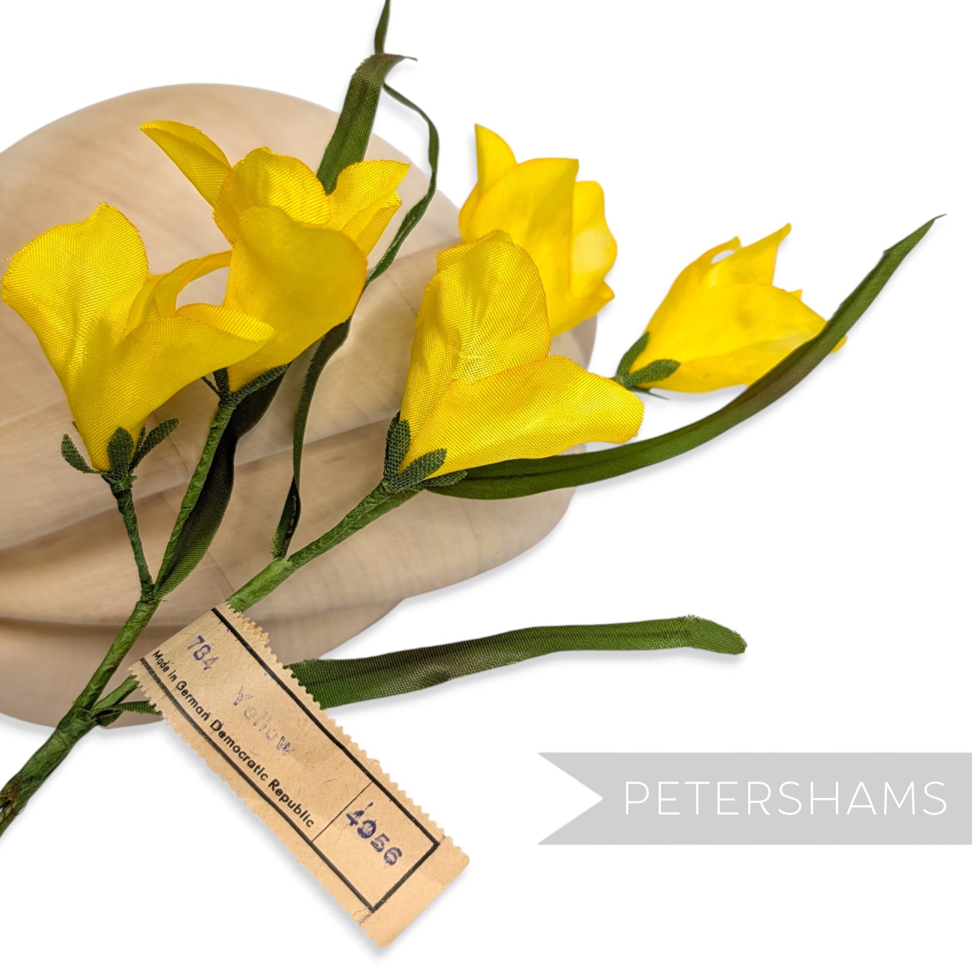 Petershams Millinery Supplies vintage 1960s yellow silk freesia flower mount with green leaves and wired stems.