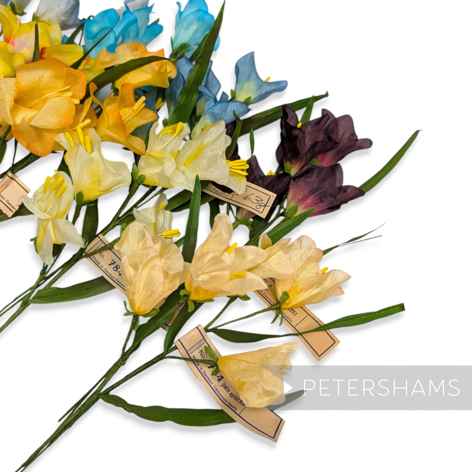 Petershams Millinery Supplies vintage 1960s German silk freesia flower mounts in yellow, blue, and purple shades.