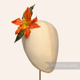 Petershams Millinery Supplies vintage 10cm silk lily flower hat mount with gradient orange petals and green leaves.