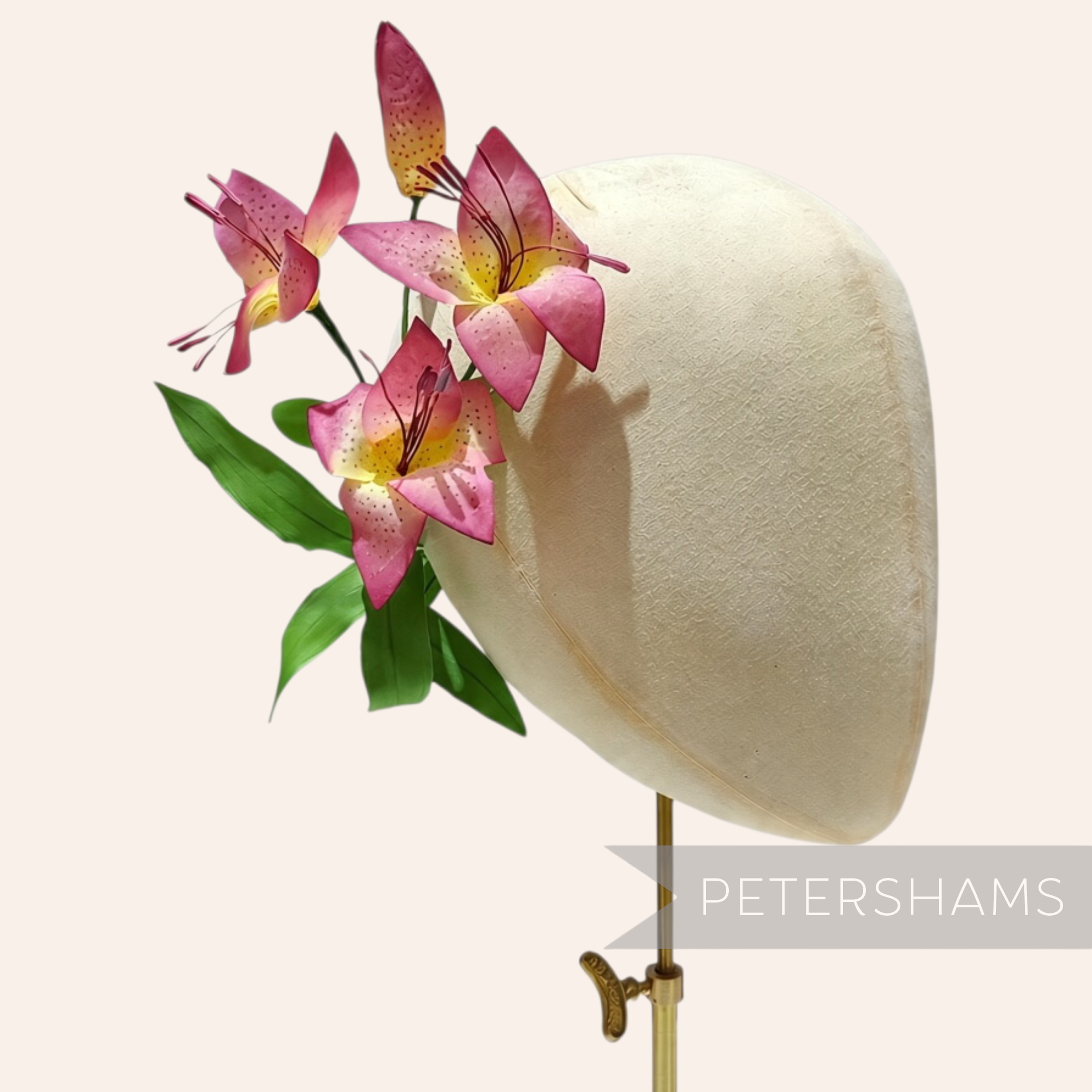 Petershams Millinery Supplies vintage 1950s silk lily flower millinery mount with pink gradient petals on a hat block