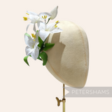 Petershams Millinery Supplies vintage silk lily flower spray with hand-painted dots on a millinery display head.