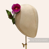 Petershams Millinery Supplies vintage 1960s pink silk rosebud flower with wired leaves on a millinery mannequin head