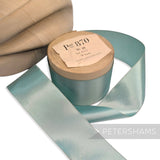 Petershams Millinery Supplies vintage Swiss satin ribbon in light blue on a wooden spool for hat making