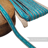 Petershams Millinery Supplies vintage 1960s turquoise and silver metallic lurex polyester trim on a wooden block