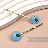 Petershams Millinery Supplies vintage 1960s turtle hair grips with hand-painted blue circular designs on gold clips