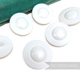 Petershams Millinery Supplies vintage 1960s UFO style white plastic shank buttons with shiny domes and satin rims.