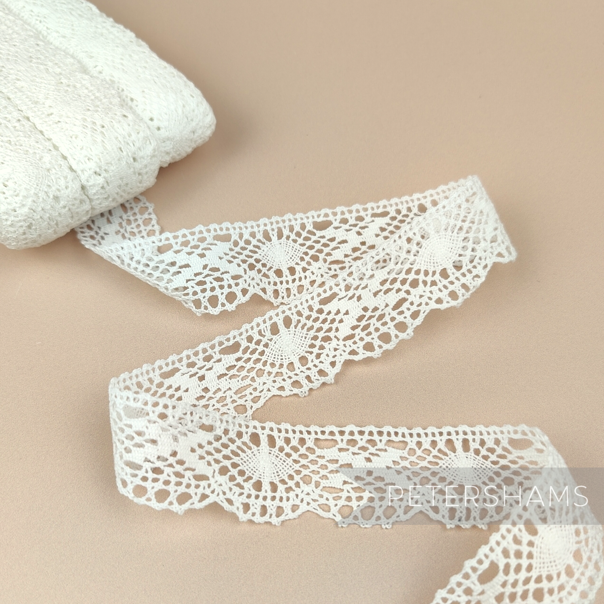 Petershams Millinery Supplies vintage 1950s white fine lace trim with cross and eye pattern, 25mm wide