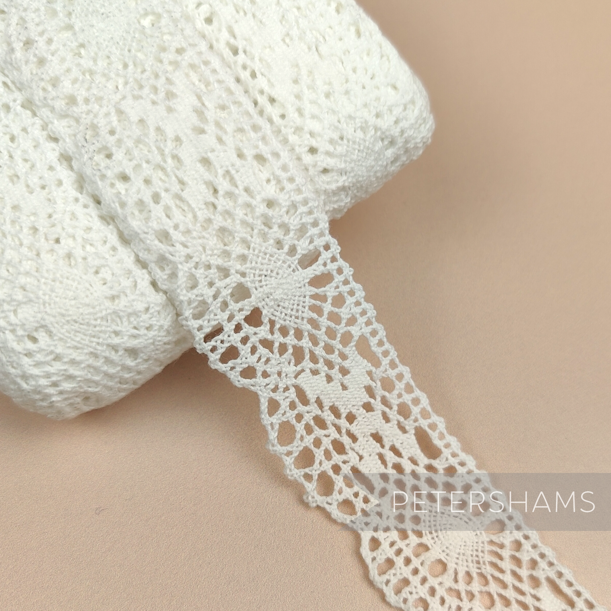Petershams Millinery Supplies vintage 1950s white fine lace trim with cross and eye pattern, 25mm wide