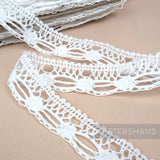 Petershams Millinery Supplies 22mm white cotton lace trim featuring an intricate dash and dot pattern.
