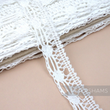 Petershams Millinery Supplies 22mm white cotton lace trim featuring an intricate dash and dot pattern.