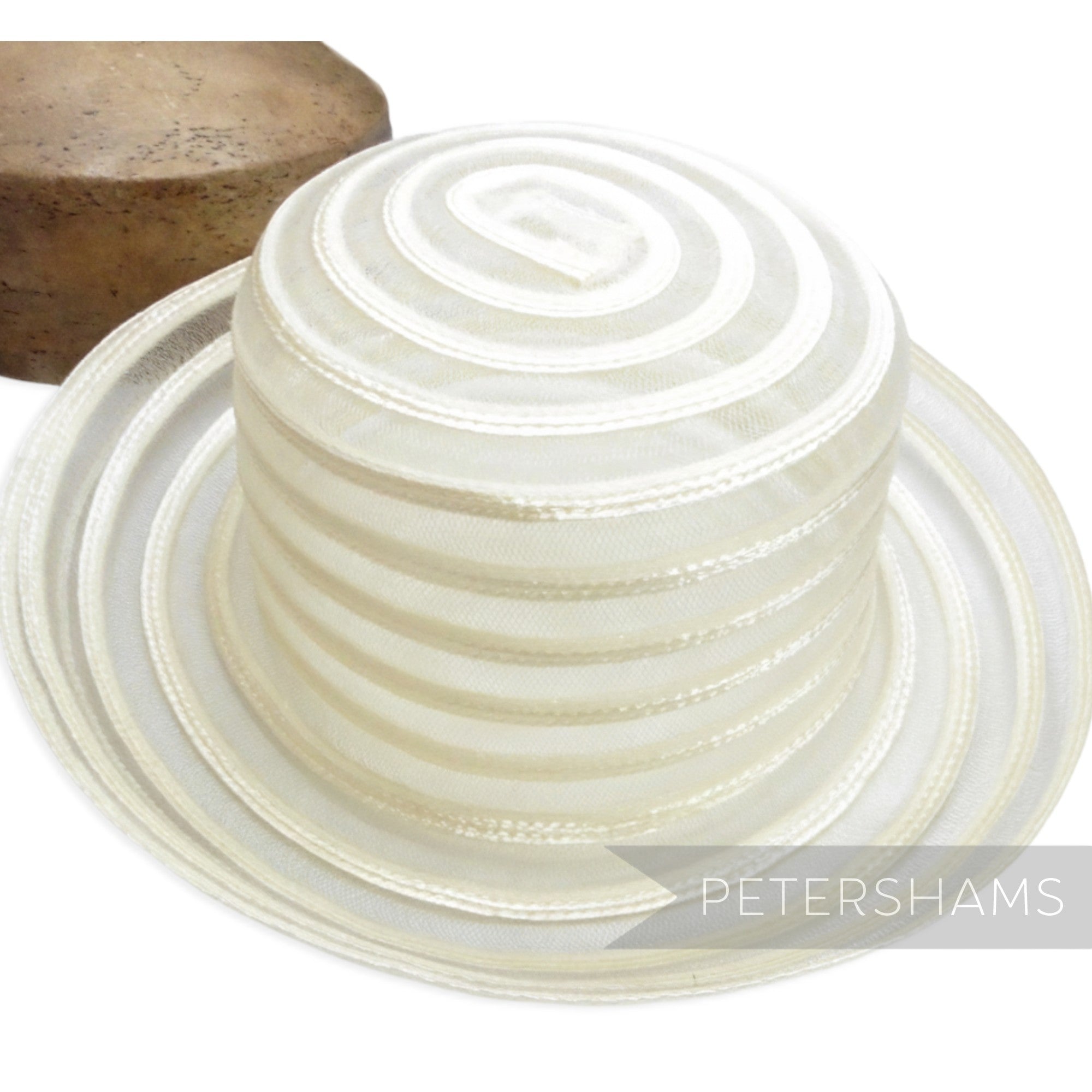 Petershams Millinery Supplies white swirled crinoline and shiny polybraid capeline hat body with upturned brim.