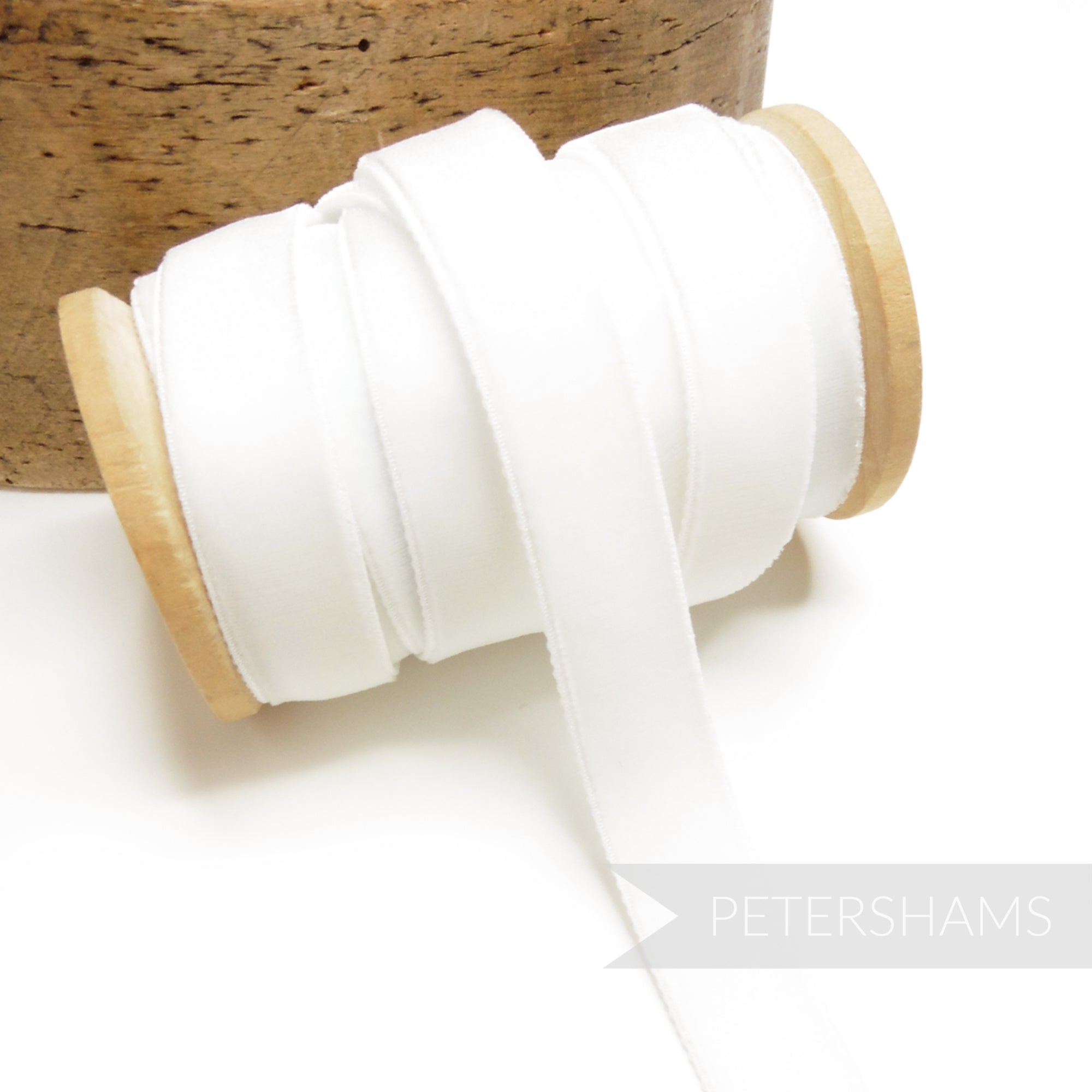 Petershams Millinery Supplies 16mm white elastic stretch velvet ribbon on a wooden spool for millinery projects