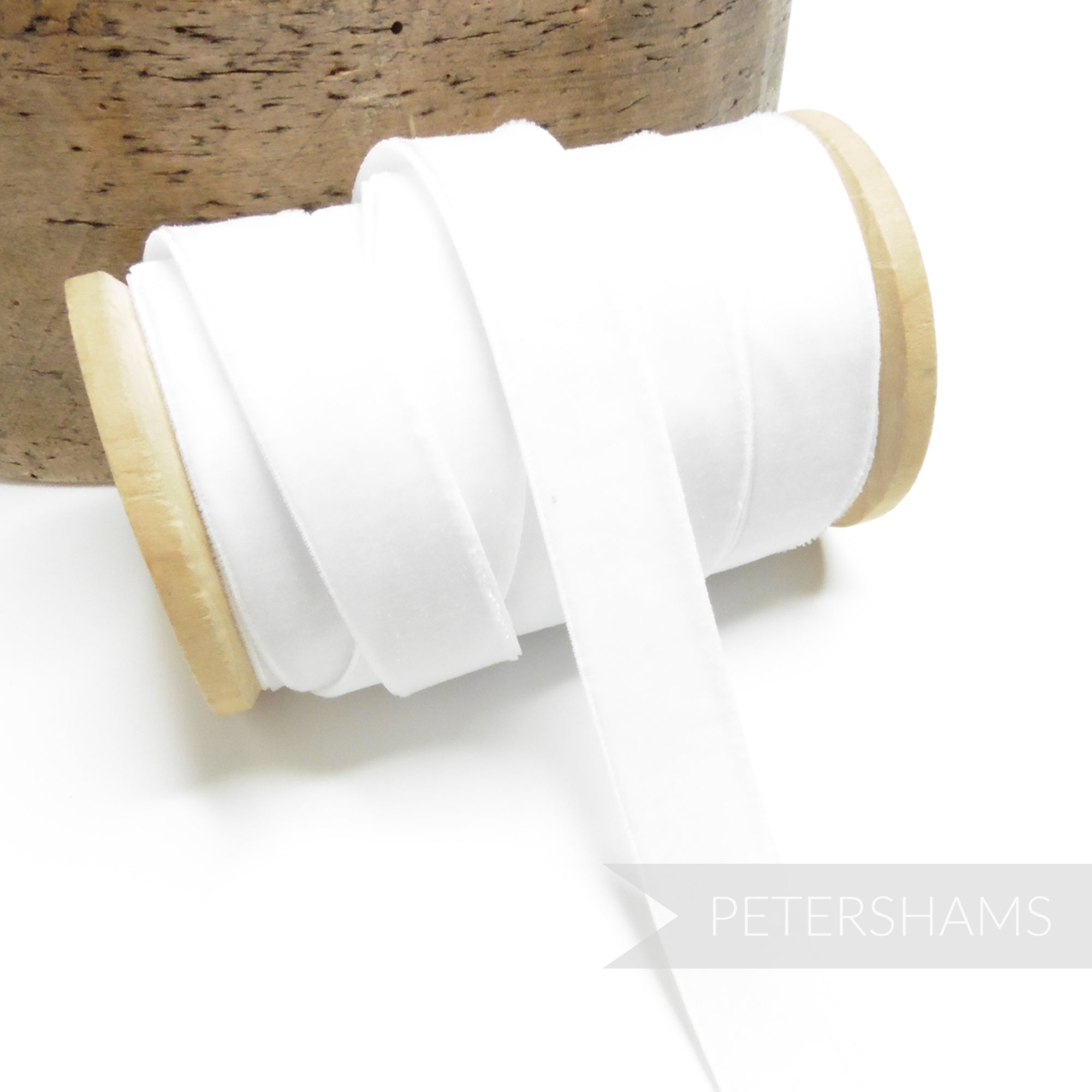 Petershams Millinery Supplies 16mm white elastic stretch velvet ribbon on a wooden spool for millinery projects