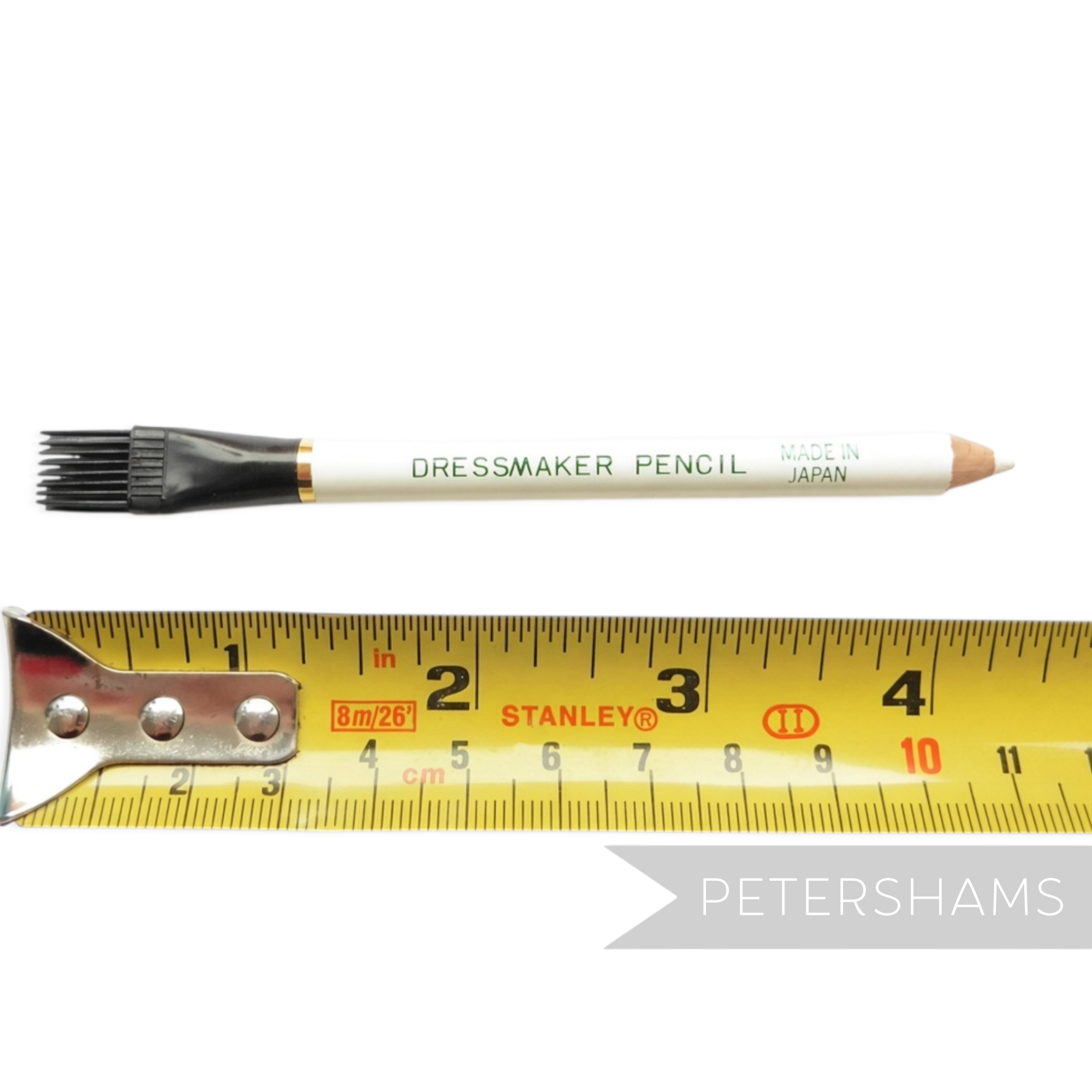 Petershams Millinery Supplies white dressmaker fabric marking pencil with a brush tip shown against a measuring tape