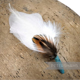 Petershams Millinery Supplies small white feather hat mount with layered pheasant and goose feathers on a jade base.