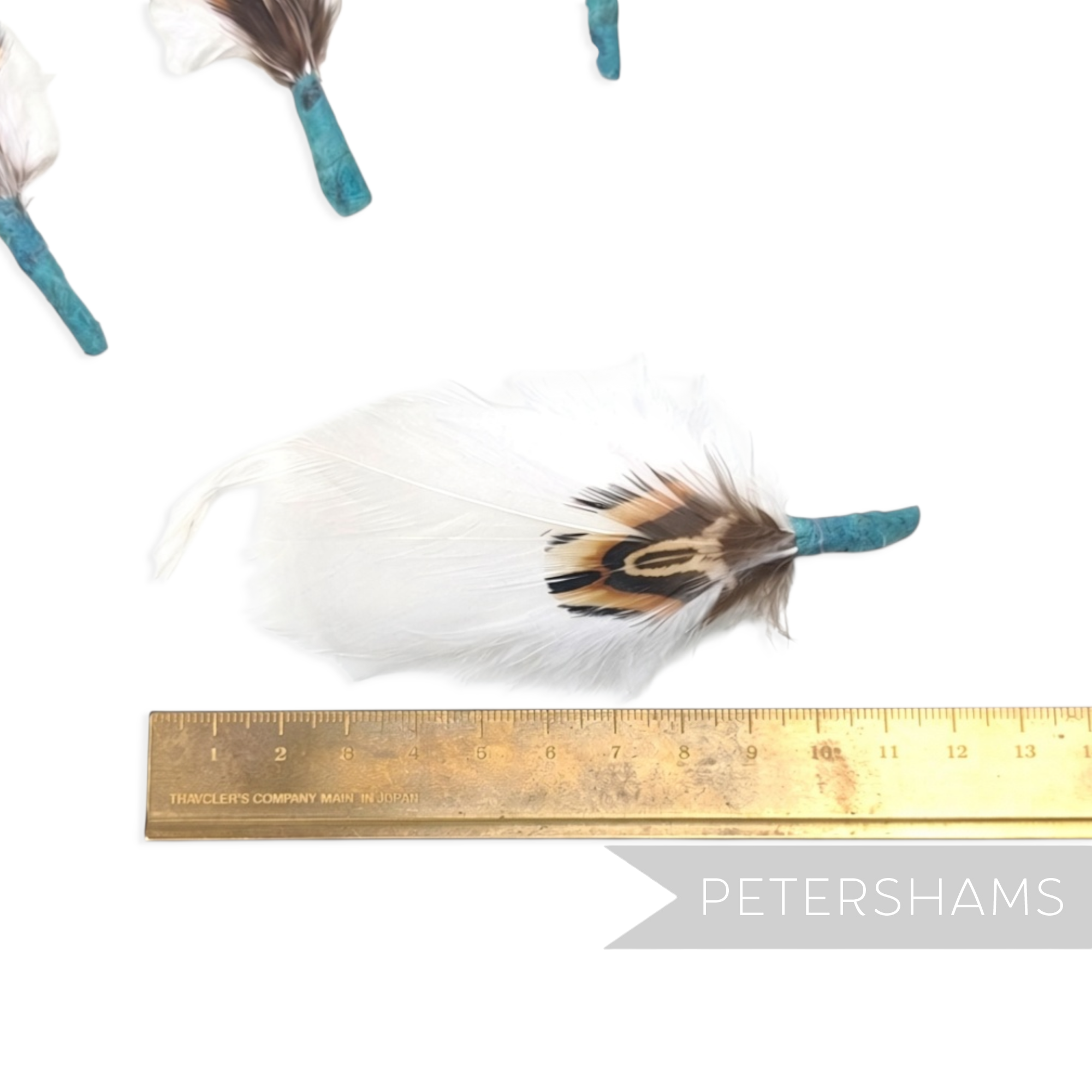 Petershams Millinery Supplies small white feather hat mount with pheasant and goose feathers on a jade tape base