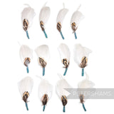 Petershams Millinery Supplies white feather hat mounts with pheasant, hackle, and goose feathers and jade tape base.