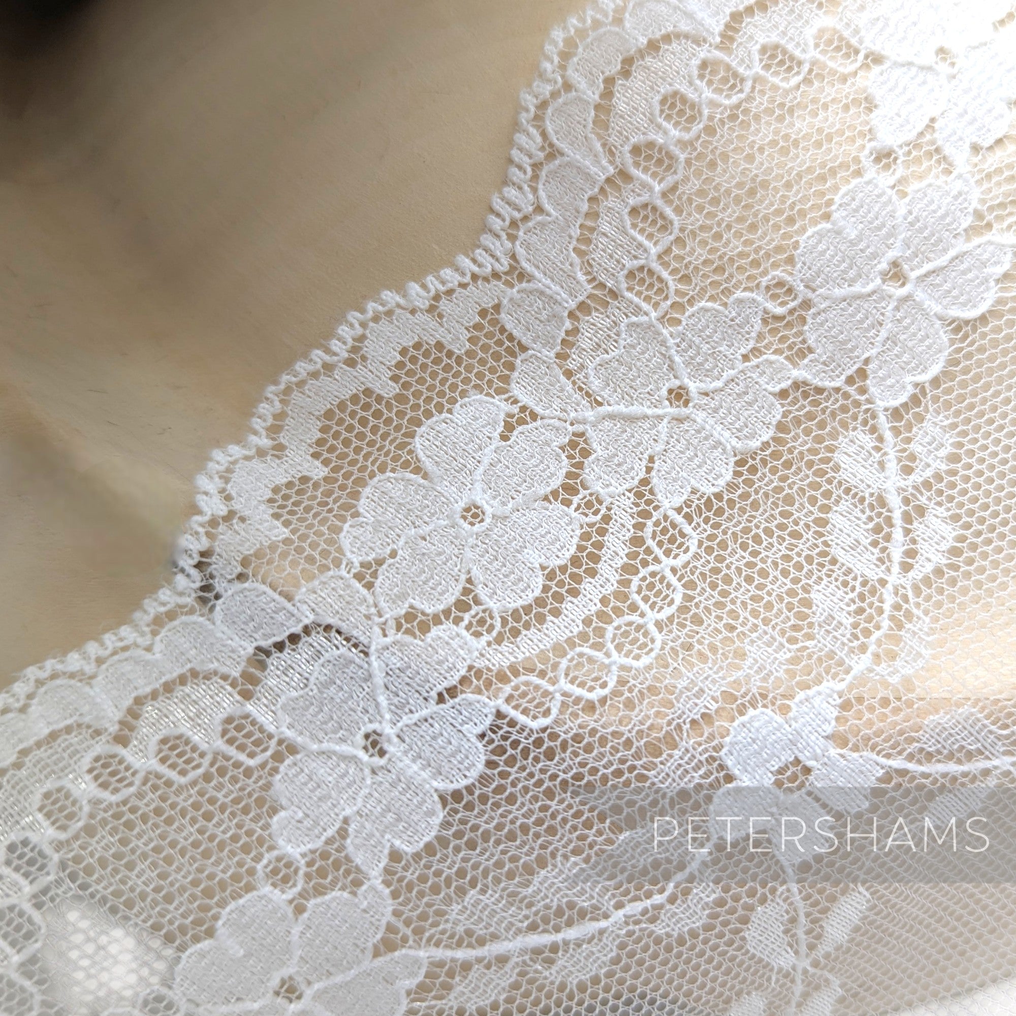 Petershams Millinery Supplies white sheer lace trim with floral scale pattern and scalloped edge for bridal veils