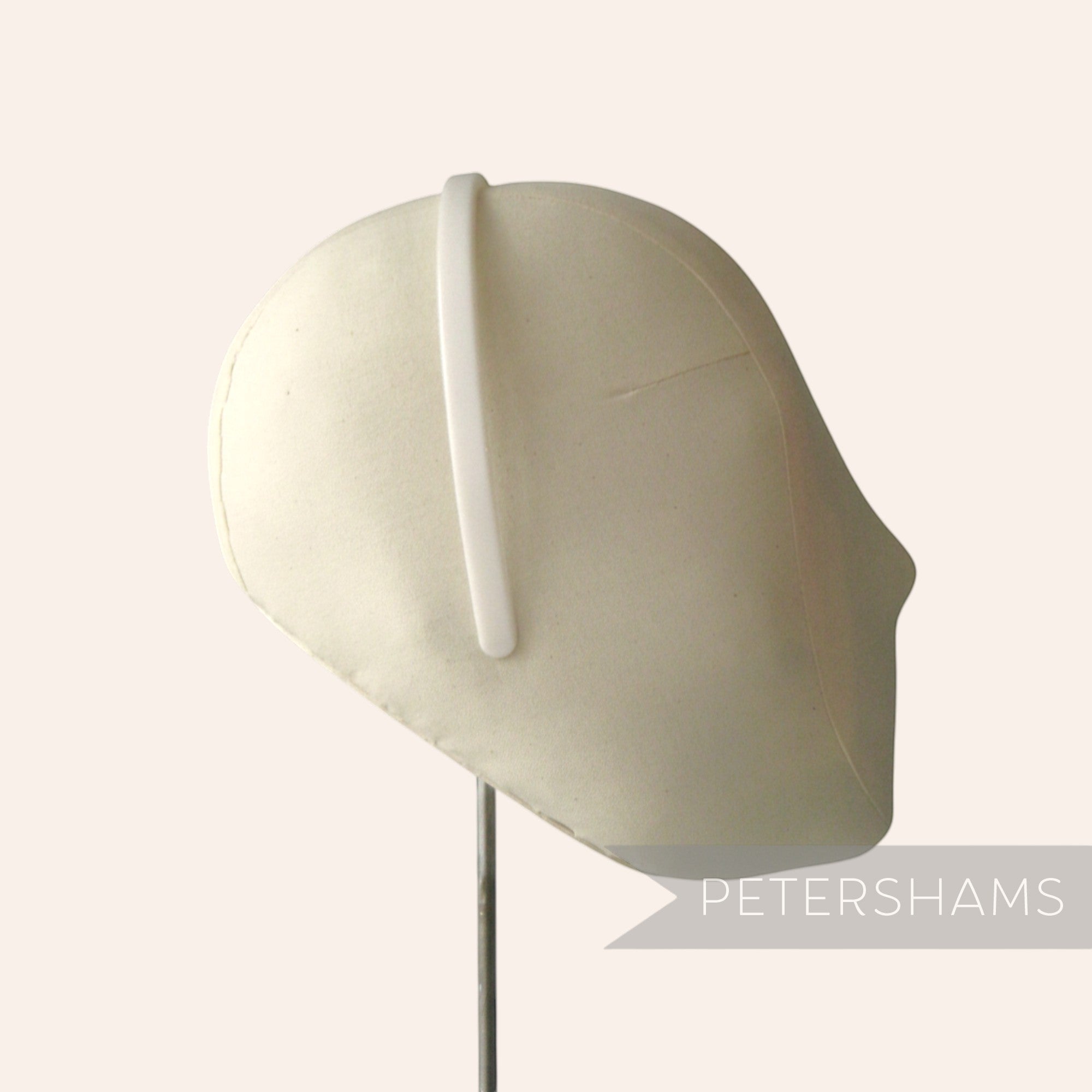Petershams Millinery Supplies white plastic headband core blank on a mannequin head for DIY craft projects