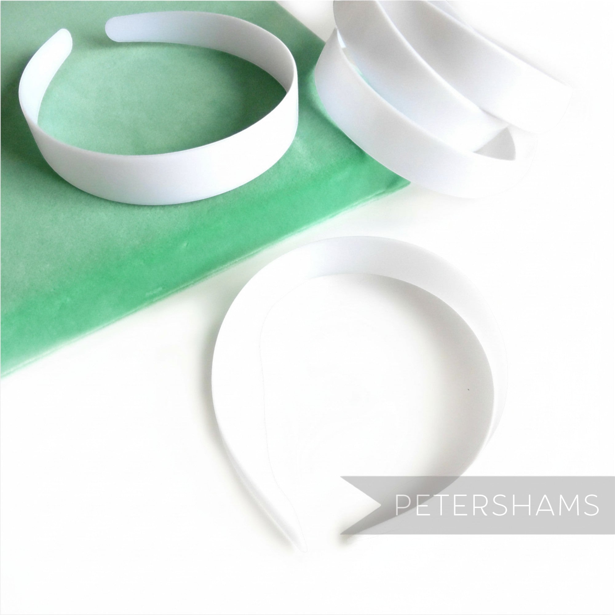 Petershams Millinery Supplies white plastic headband core blanks for DIY craft and millinery projects.