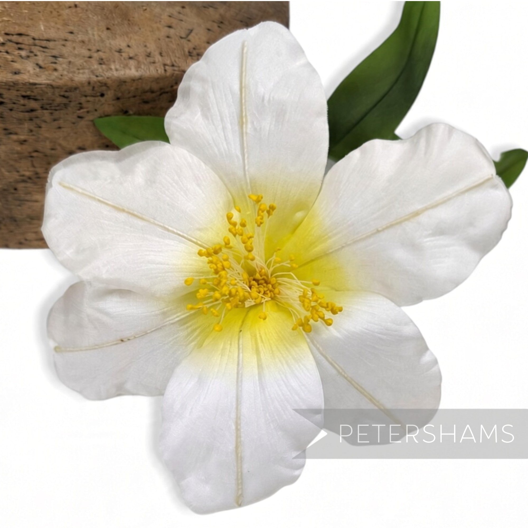 Petershams Millinery Supplies vintage ivory silk hibiscus flower with yellow stamens and green leaves