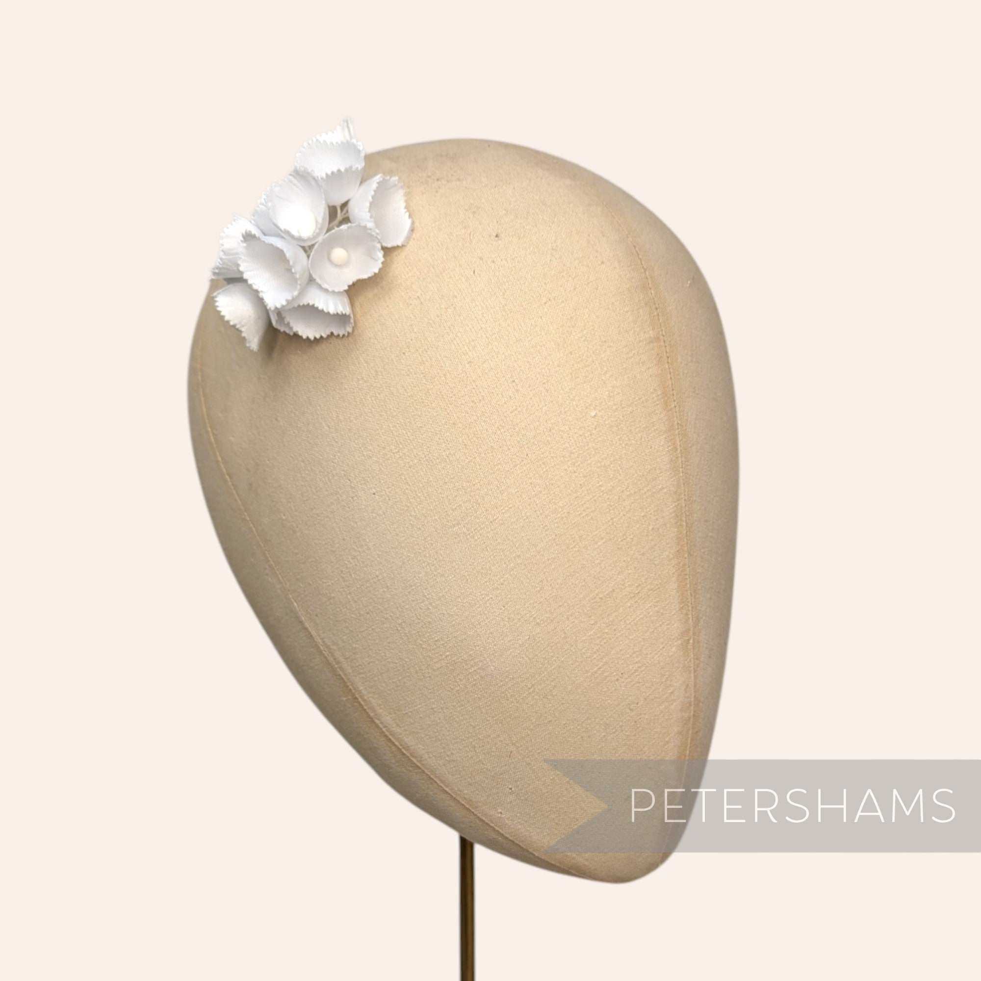 Petershams Millinery Supplies Claudia small white silk lily of the valley flower stems on a millinery head block