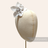 Petershams Millinery Supplies white silk orchid flower hat mount displayed on a millinery head block