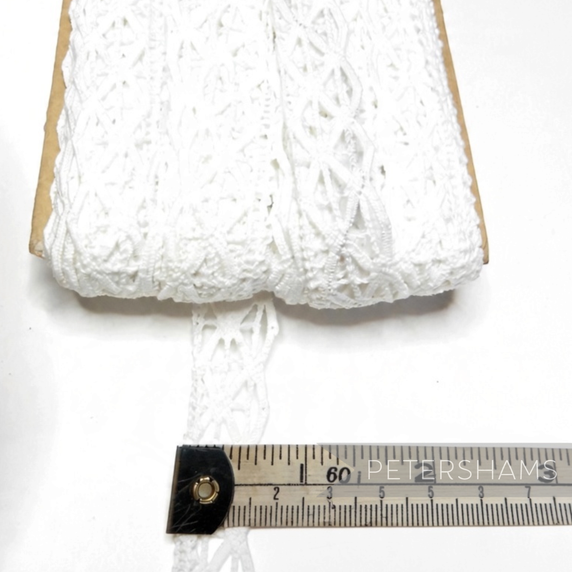 Petershams Millinery Supplies white cotton lace trim with a geometric triangle pattern, 20mm wide on a spool.