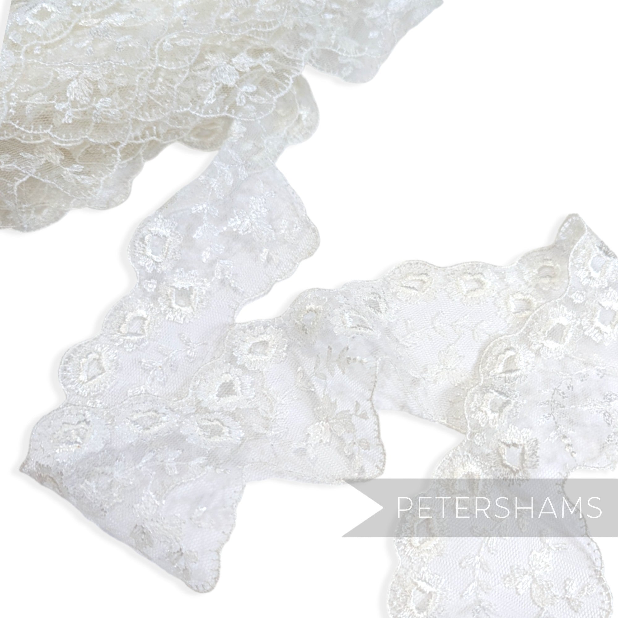 Petershams Millinery Supplies 80mm white embroidered tulle lace trim with eyelet, leaf spray, and scalloped edges.