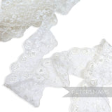 Petershams Millinery Supplies 80mm white embroidered tulle lace trim with eyelet, leaf spray, and scalloped edges.